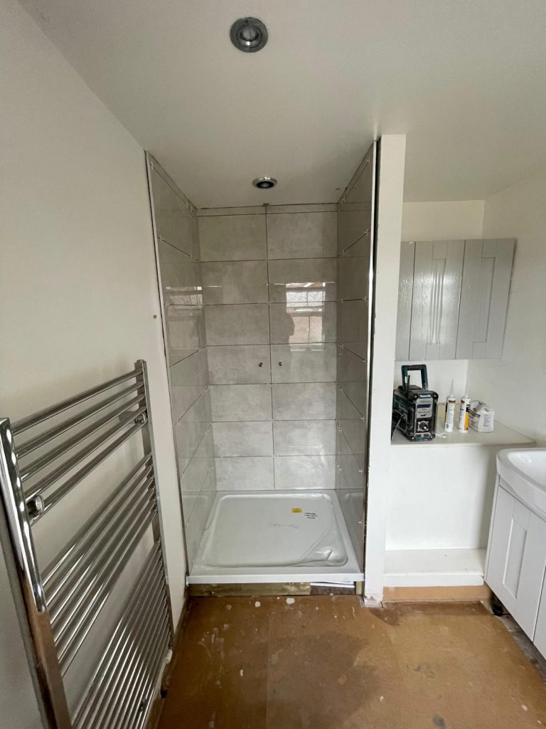 Shower room installation Reading with heated towel rail and grey tiles