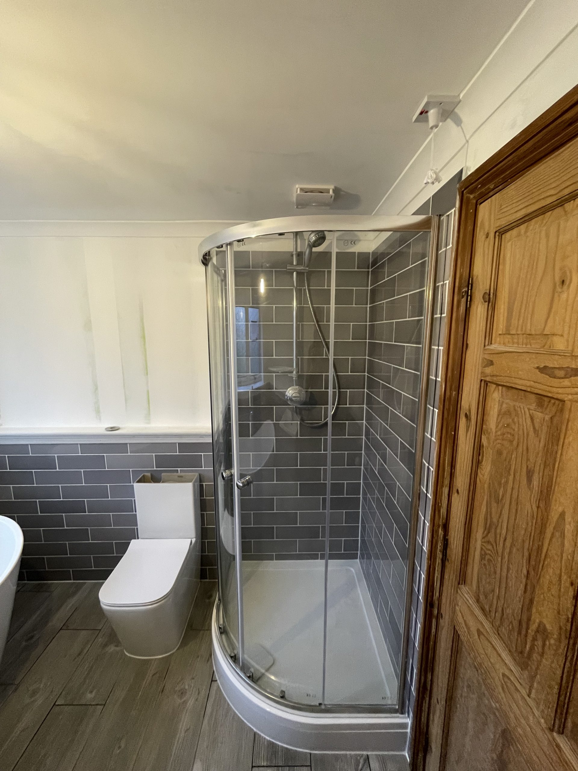 Shower room installation Reading with grey tiles and toilet