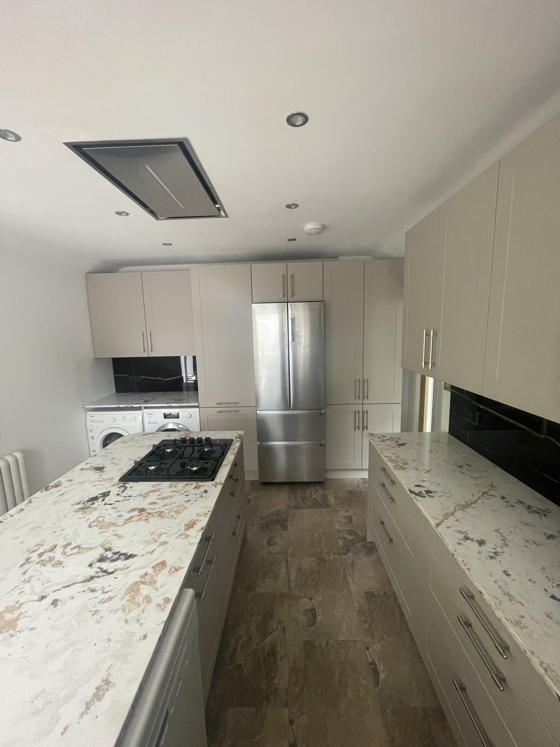 Modern kitchen refit Reading with white cabinets and marble worktop